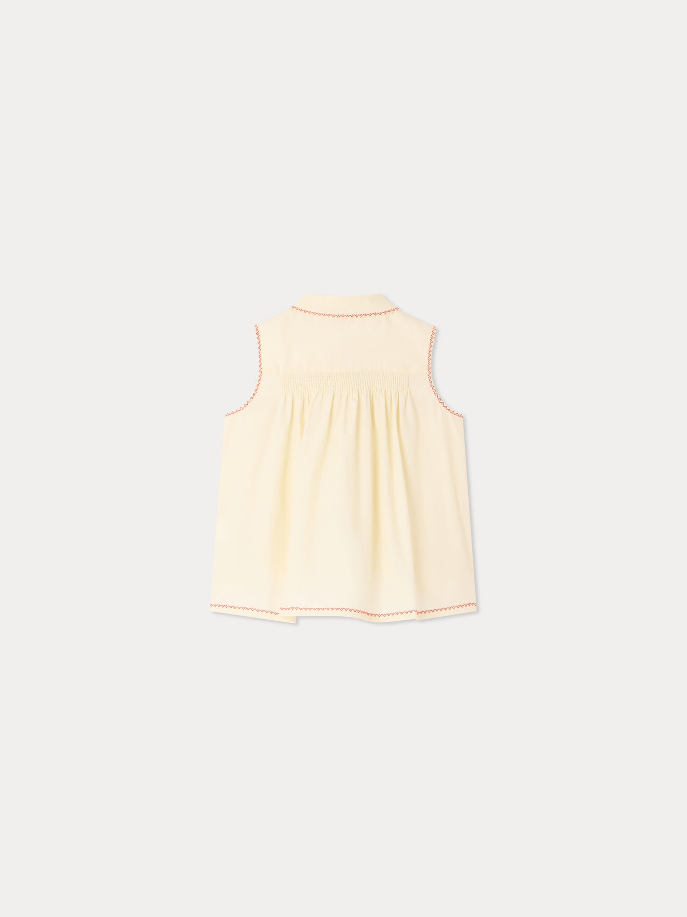 Camicetta Lexi con smock e ricami fatti a mano in cotone bio