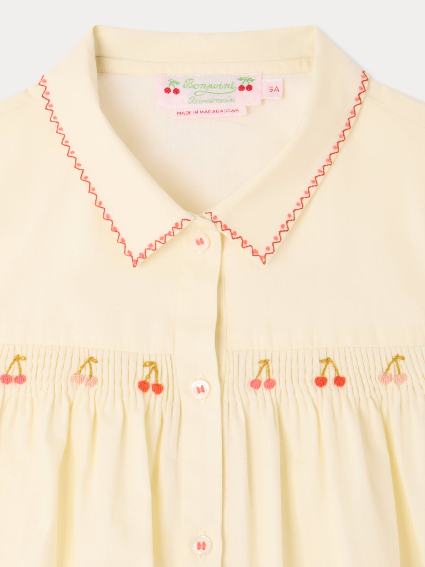 Camicetta Lexi con smock e ricami fatti a mano in cotone bio